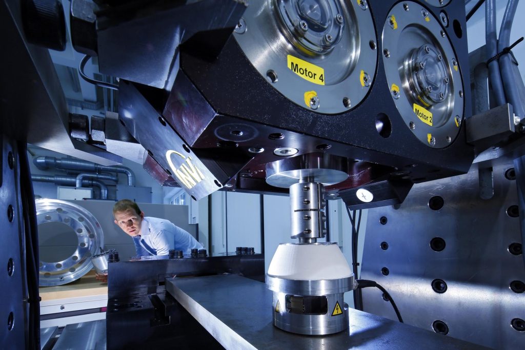 File:Test Bench at the Fraunhofer LBF for active vibration control.jpg - a man working on a machine