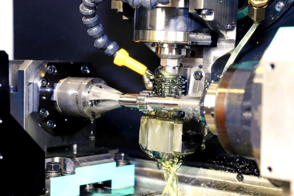 Gear-hobbing-spur-gear-on-cnc-cutting-machine - a machine that is cutting a piece